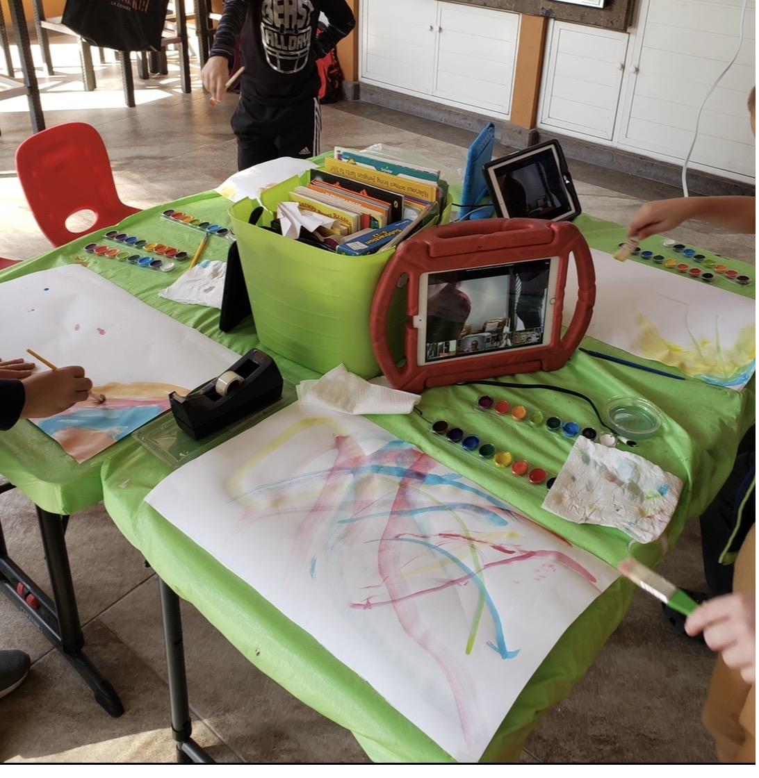 Pandemic-era classroom: half watercolor, half iPad screen — the literal embodiment of half screens, half human presence